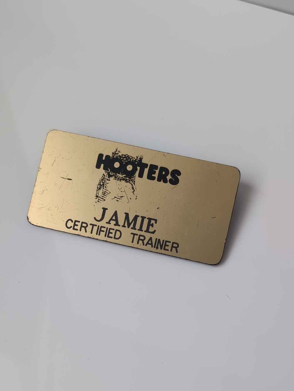Hooters Gold Name Badge with Black Logo and Text